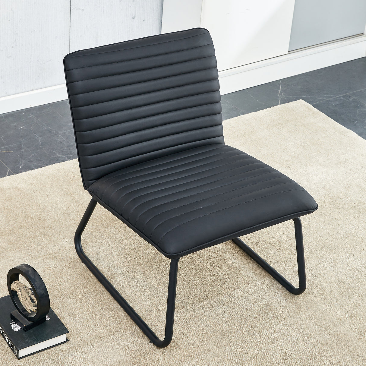 Black minimalist armless sofa chair with PU backrest paired with black metal legs